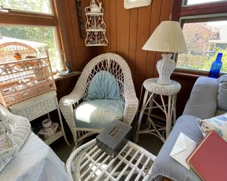 Corner of sunroom, wicker rocking chair and other wicker furniture 