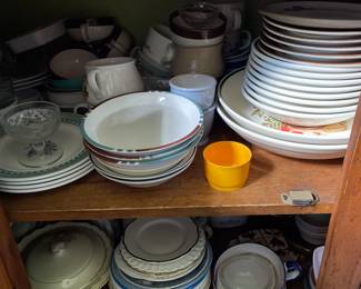 One kitchen cabinet of ceramic plates and dishes 