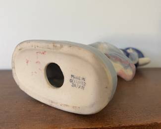 Bottom of ceramic white and blue statue of woman 