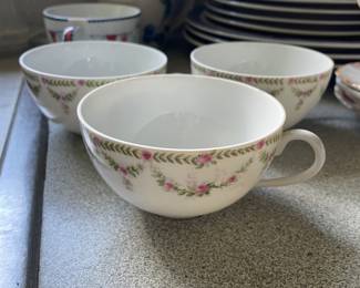 Set of three white, pink, green floral ceramic cups 