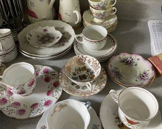 Assorted tea cups and saucers in kitchen 