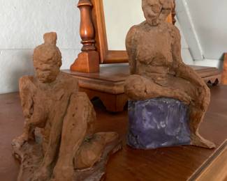 Two heavy statues of female figures 