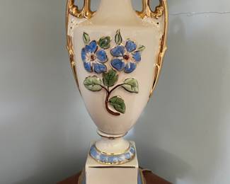 Closer look at decorative floral, white, gold lamp 