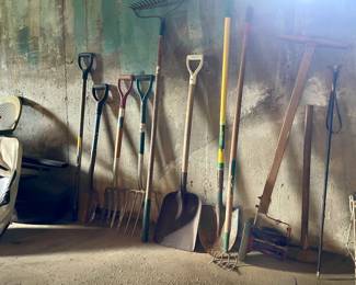 Assorted gardening tools in basement 