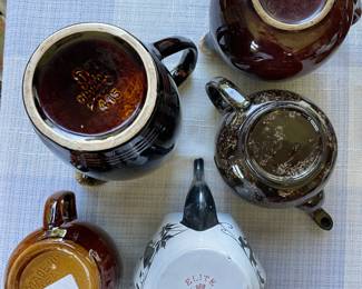 Bottom side of assorted, Earth-tone teapots 
