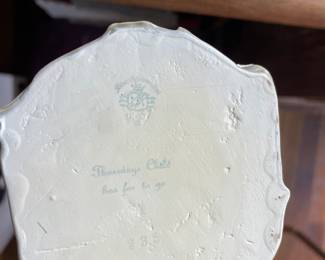 Bottom side of English man and woman ceramic statues 