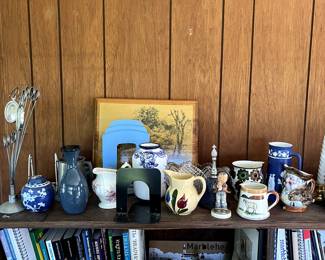 Assorted ceramic dishes and vintage books in sunroom 