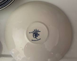 Bottom side of blue and white ceramic cup and matching saucer 