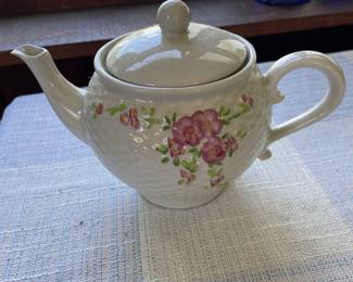Textured white ceramic teapot with pink and green floral design 