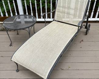 Patio chaise lounge chair; metal patio side table.