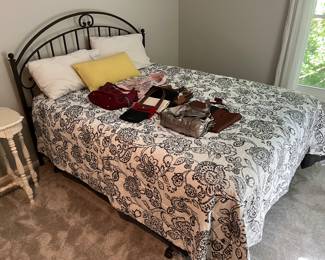 Queen-size bed with metal headboard, mattress and box spring.