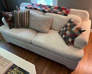 One of two matching upholstered couches by Krause’s Sofa Factory; throw pillows.