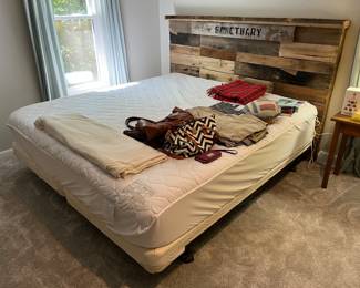 King-size bed with mattress and box spring. Closer look at headboard in following photo.