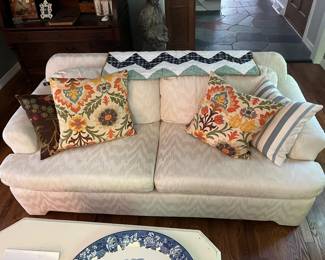 One of two matching upholstered couches by Krause’s Sofa Factory; throw pillows.