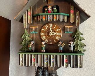 Charming German made vintage chalet style cuckoo clock featuring Oompah Band characters, and children that twirl and spin every half hour. Absolutely delightful!