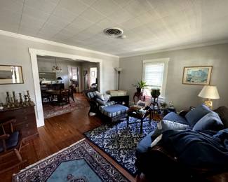 Living room - wicker couch and ottoman set, oriental rugs, lamps, dresser, mirrors
