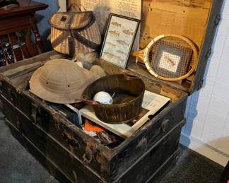 Old trunk with vintage fishing and other sports items