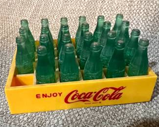 Vintage miniature plastic Coca-Cola bottles in crate
