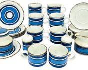 FINE STAFFORDSHIRE ENGLISH MIDWINTER POTTERY STONEWARE TABLEWARE INCLUDES CUPS SAUCERS LIDDED JAR CREAMER AND DESSERT DISHES WITH SALT AND PEPPER SHAKERS
