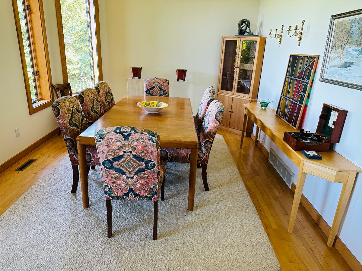 Teak dining table (63" long without leaves plus two leaves 20" w and 48" w for maximum length of 131") with 8 upholstered chairs and teak corner hutch