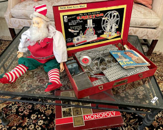 Old St Nick and erector set. Monopoly too.  Also, coffee and two end tables. Iron and glass.   There is a wool rug in this room too. 