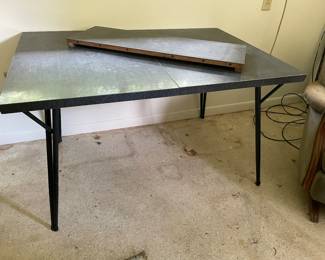 Mid century modern . And the iron legs fold up.  I just discovered it folded up  put away in the apartment 
