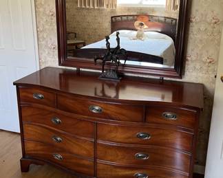 This mirrored dresser is in the same room as the full bed and has quite the style to it.