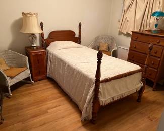 Here we have a twin-sized bed.  There are two wicker chairs in the room, along with the dresser and night stand.  The blue lamp is pretty cool, too.