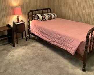 One of the beds available in the sale.  This twin-size has the well-styled head and foot boards.  There is also a night stand, lamp, and short bookcase.