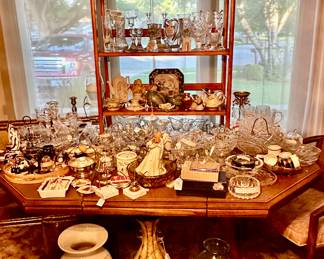 A Dining Room Table under there by filled with Crystal, Art Glass and Porcelain Figurines