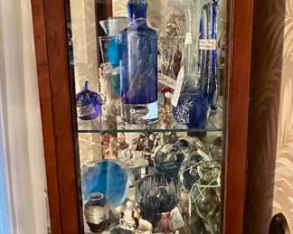Display case is filled with Blenko Art Glass, Tiffany Decanter and More.