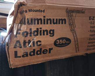 new-in-box aluminum folding attic ladder