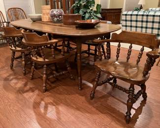 Table with six captains chairs and three extension leaves 42”x60”, 72”, 84”, 96”