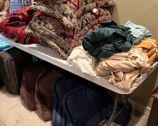 Several sets of queen sheets and bedding 