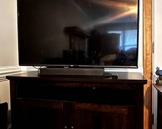 Two televisions, two sound bars, lots of DVD's and CD's, a DVD player, and computer accessories.