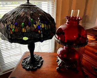 Several antique lamps and some modern table top stained glass