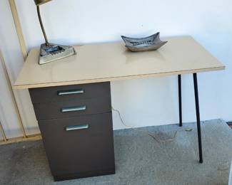 This vintage school/office desk features a solid beige desktop in excellent condition, two drawers, and a large storage cabinet. It measures 40" long, 18" wide, and 29 1/4" tall.  The lamp and dish in photo are sold separately. 