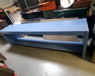 We are selling this long solid wood end or wall table. The table is painted teal and measures 82 1/2" long, 15 3/4" wide, and is 24" tall. It features one long shelf for convenience. Ideal for a business, school, play room, or garage. 