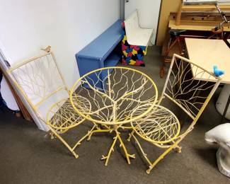 From France, this unique and vintage patio table and chairs is a one of a kind!  It features two folding chairs with steel birds and a unique tree branch design.  Made of solid steel. 