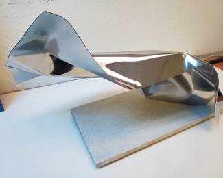 We are offering this beautiful stainless steel in stone sculpture from listed artist and sculptor Juan Carlos Munoz-Hernandez of Los Angeles for your consideration.  This spectacular piece is titles Light Sound and Water is presented on a black wood base.  It measures 21 1/2" wide by 14 1/8" tall.  The base of the sculpture measures 17 1/2" long by 8 1/2" wide.
