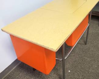 We are selling this vintage 1960's school desk purchased in 2004 in Cheyenne, Wyoming.  The desk is made of solid construction steel, painted orange, with a beige wood composite top.   