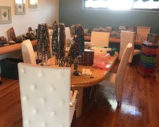 full shot of dining room table and the chandelier Beads by the mile on the hangers