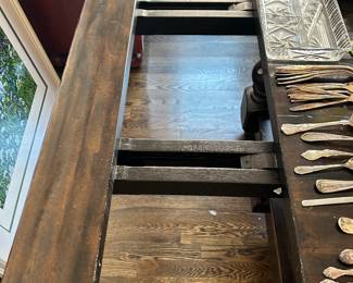 Dining table has bread board ends, each pulls out for a leaf