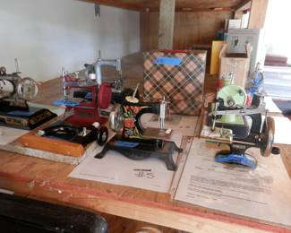Collection of child's sewing machines over several decades and from many countries.....next photo has more