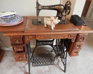 Antique Singer treadle sewing machine....Rare to find in this condition....carved tiger oak cabinet and drawers