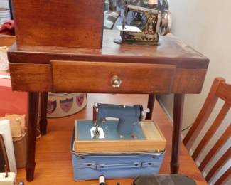 Rare dimutive childs sewing machine and cabinet.