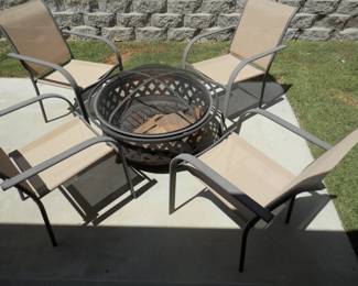 Outdoor fireplace with fitted screen cover and 4 chairs