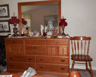 Louvered M-C 10 drawer maple dresser with mirror....early American spearback,  scoop seat chair also of solid maple....cranberry glass antique hurricane lamp.on right.....left one has been taken by family