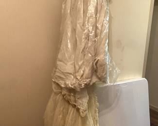 Altar gown and possibly an antique wedding gown or dress (lace with flowers)