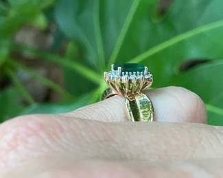 $275- Emerald cut center stone 1ct approx, on 14kt yellow gold setting ring SZ 6